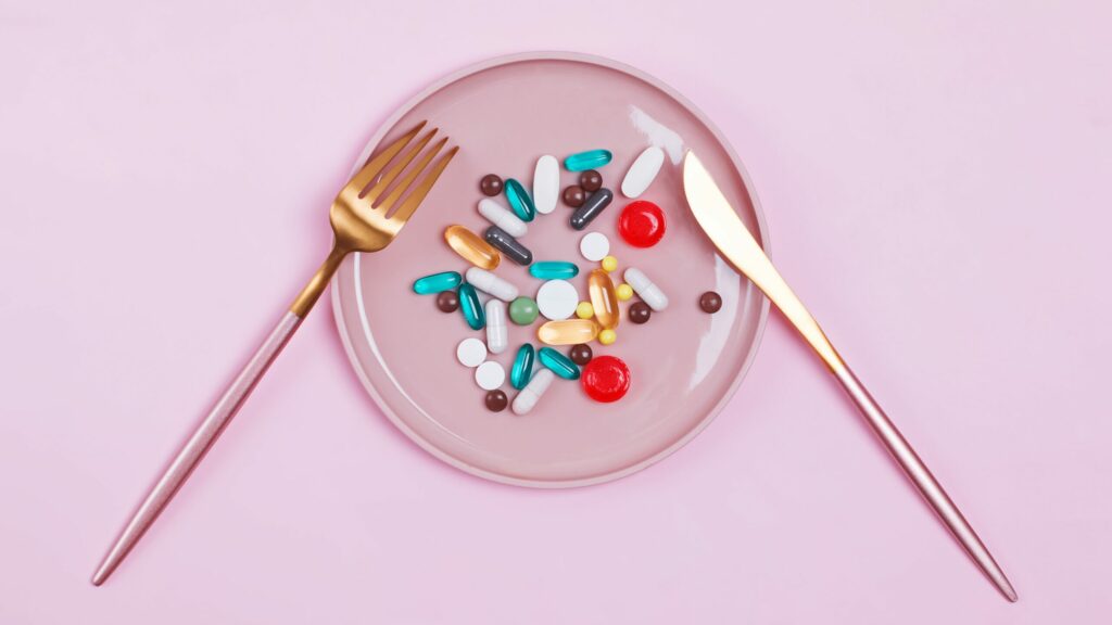 Brightly coloured pills on a plate