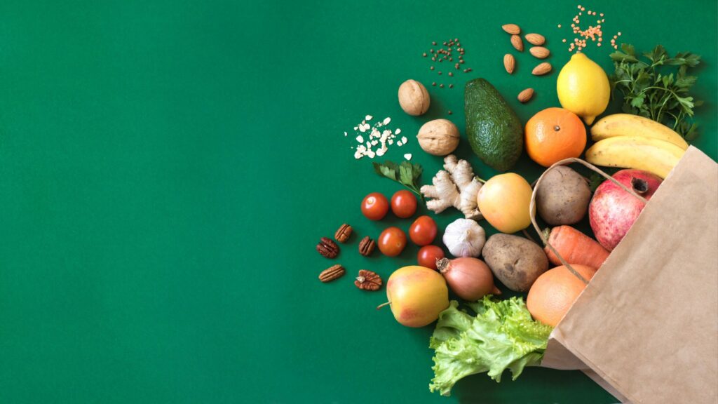 Fruit and veg coming out of a brown paper bag