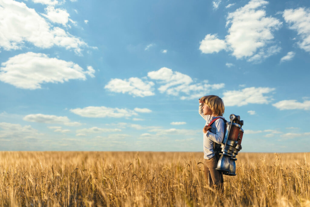 header image; person in field